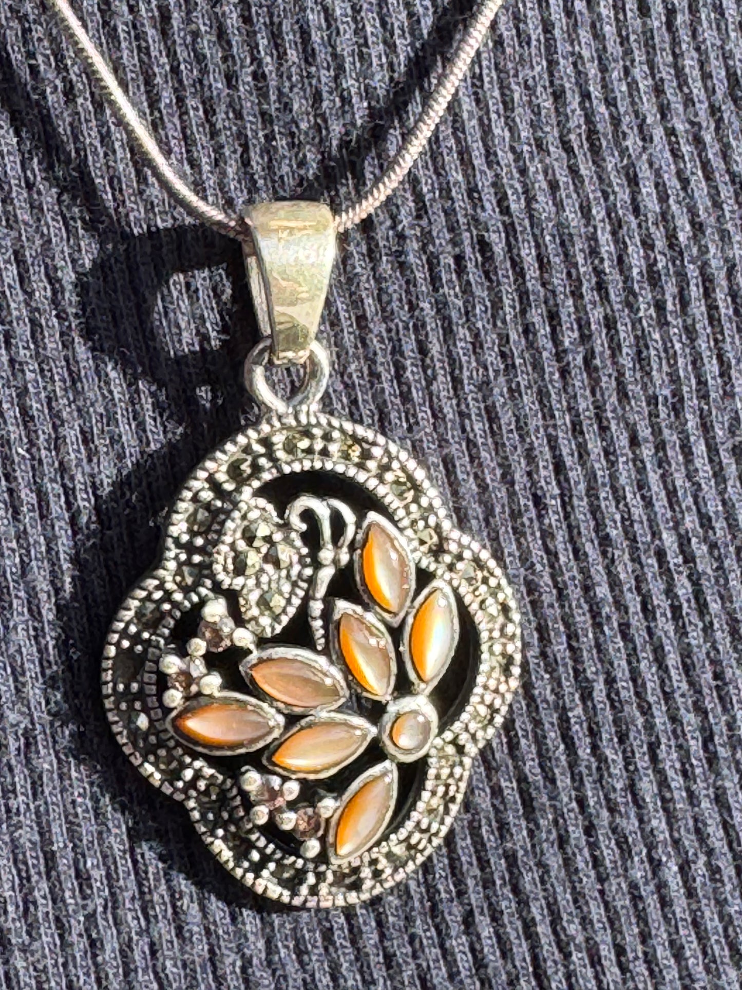 THE BROWN MOTHER OF PEARL FLOWER WITH MARCASAITE NECKLACE